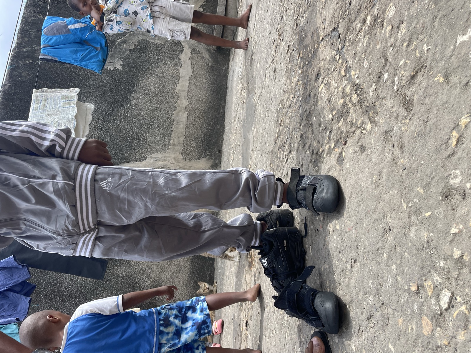 Athman smiling with his new shoes